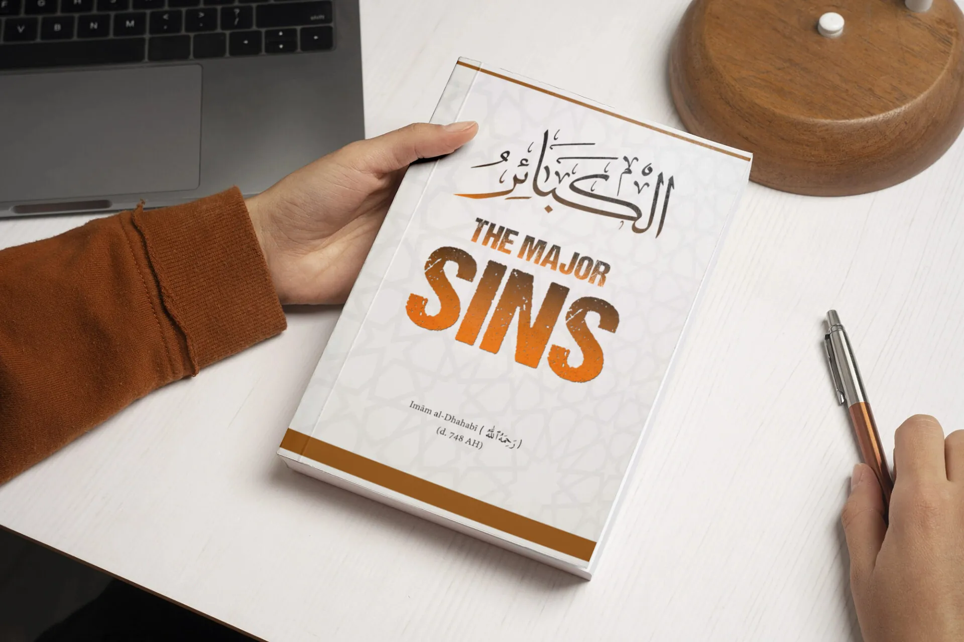Islamic Book Cover Design – “The Major Sins” by Imām al-Dhahabī 17 Person holding and reading a book at home